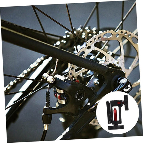 Close-up of a bike wheel with disc brake showing Hydraulic Hose Fitting Insert Tool For Bicycles With Needle Driver And Detachable Thimble Lock