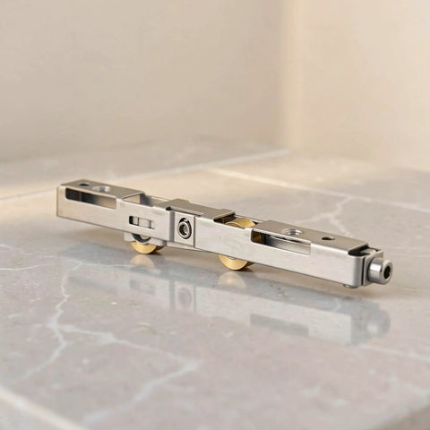 Top Tier Sliding Door Replacement Rollers Engineered For Legit Heavy Duty Use And Butter Smooth Gliding Action To Permanently Stop Squeaks And Sagging On Shower Patio Or Window Tracks Today, stainless steel rollers on marble surface.