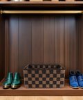 Top Shelf Clothing Storage Bin With Reinforced Metal Frame And Grippy Polyester Weave Handles tucked beside blue and green shoes.