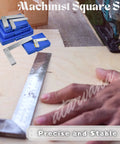 Machinist square set with 2–6 in steel L-shaped squares in blue cases on a woodworking bench