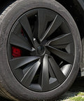 Premium Matte Black 19 Inch Spiral Aero Wheel Covers Sweet Fit For Tesla Model Y Juniper close-up on tire and wheel design.