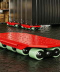 Heavy Duty Machine Dolly Low Profile Moving Cart With Thickened Steel Plate, red with multi wheels, in a workshop setting.