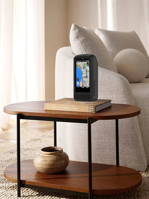 Rugged Soft Shell Case For ELEMNT ROAM V3 GPS Cycling Computer on a wooden table, silicone leather blend, black finish.