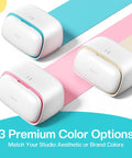 Three S501 Vinyl Cutter Machine Portable Plotters in different colors: blue, pink, and gold, arranged diagonally on colored surfaces.