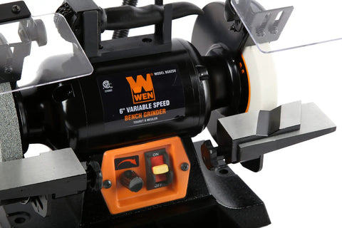 Close-up of Top Shelf 6 Inch Bench Grinder With 2.5 Amp Variable Speed Motor and Built In Work Light, showing controls and grinding wheel.