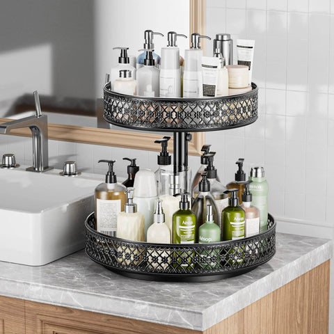 Two-tier black metal 12-inch lazy Susan turntable on kitchen counter, filled with lotion and soap bottles.