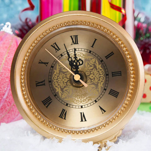 Gold analog clock with intricate black hands and Roman numerals, showcasing DIY Clock Movement Kit Quartz Battery Operated Replacement Mechanism With Two Pairs Of Short Hands For Easy Home Clock Repair Timekeeping Upgrade And Do It Yourself Projects.