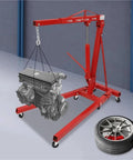 Heavy Duty Garage Workhorse: 2 Ton Hydraulic Engine Hoist, red steel frame lifting car engine, adjustable range with wheels.