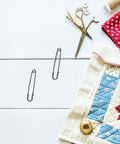 Luxurious Heavy Duty Safety Pins For Women Thick Iron Sweater Clips on a quilted surface with sewing tools.
