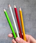 Hand holding four colorful pencils including Jumbo Round Pencil 24 Pack Red With Medium Lead, USA Made Cedar Wood