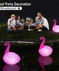 Family enjoying nighttime ambiance with Solar Flamingo Floating Pool Lights 4 Pack, Solar Powered LED Flamingo Lights at pool party.