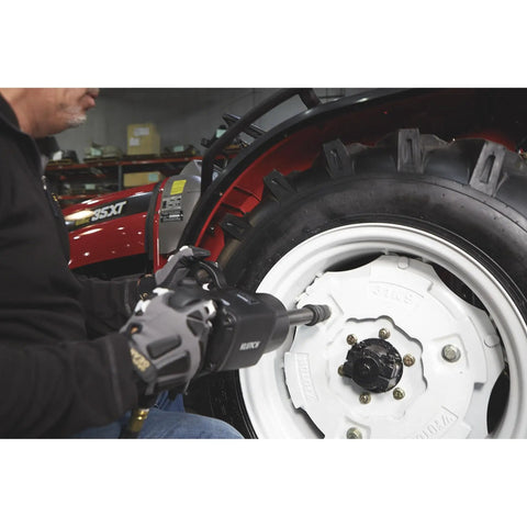 Person using Heavy-Duty Air Impact Wrench With 8 Inch Anvil And D-Handle on a vehicle wheel in a shop