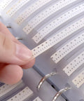 Person handling strip from Massive 0603 SMD Resistors Kit One Percent Value Pack With 170 Resistor Values, 50Pcs Each, 8500Pcs Total