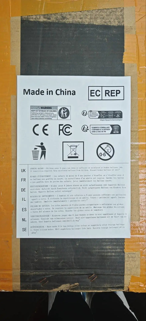 Label showing warning, CE, FCC marks, and recycling info on cardboard, made in China notice.