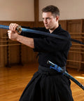 Man practicing Iaido with Beast Mode Spring Steel Katana Hand Forged Plum Blossom Samurai Sword for Practice and Display