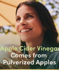 Woman smiling while holding a white cup, representing Straight Up Apple Cider Vinegar Supplements 480 Mg Daily 200 Count Tablets.