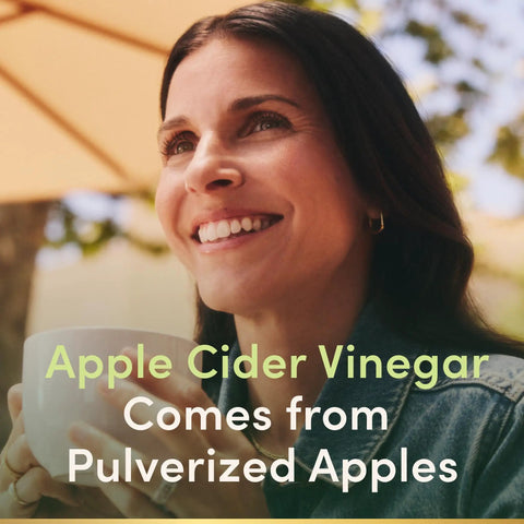 Woman smiling while holding a white cup, representing Straight Up Apple Cider Vinegar Supplements 480 Mg Daily 200 Count Tablets.