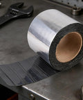 Self Adhesive Asphalt Sealer Tape For Waterproof Crack Repair on workbench, revealing aluminum backing and adhesive surface.