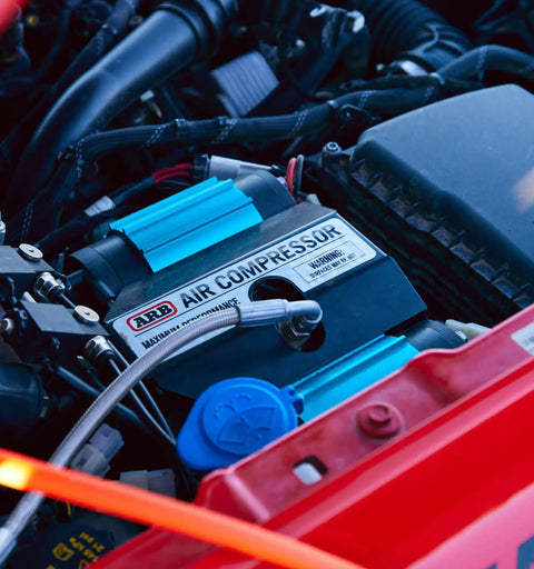 CKMTA12 12V On Board Twin High Flow Air Compressor in engine, showing sealed motor and compact design for offroad use