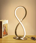 Eight Shape Spiral Led Table Lamp With Stepless Dimmable Brightness Warm White Light Modern Silver Nightstand Desk Lamp beside books