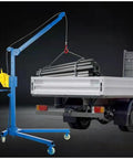 Heavy Duty Portable Hoist Stand Foldable Workshop Engine Crane With Two Way Self Locking Winch lifting metal pipes from truck.