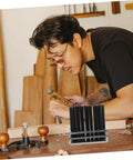 Craftsman using essential cylindrical punch set for woodworking and metalworking, pro grade hole making and repair tool kit.