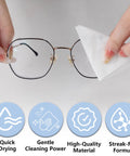Front view of gold-rim eyeglasses being wiped by tissue; Giaceaw 500ct pre-moistened lens wipes, individually wrapped.