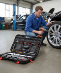 Man using a 314 Piece Mechanic Tool Set Built Like A Tank With 1/4 3/8 And 1/2 Inch Drive Metric Sockets on a car tire.