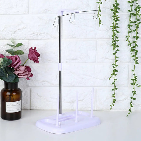 Top Tier 15 Bobbin Thread Stand For Sewing Machines, Rock Solid Embroidery Spool Holder With Slick Thread Flow, Effortless Operation Home Sewing Organizer, Purple in a modern home setting.