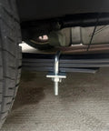 Leaf Spring Clamp Kit Fits Up To 2.5 Inch Wide Leaf Springs, mounted under a truck for axle torque control, close-up view