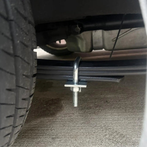 Leaf Spring Clamp Kit Fits Up To 2.5 Inch Wide Leaf Springs, mounted under a truck for axle torque control, close-up view