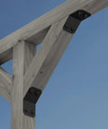 Avant Collection ZMAX Black Powder Coated Knee Brace Connector For 6X Lumber attached to wooden beam on outdoor structure.