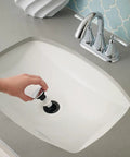 Hand installing Drain Stopper For Push And Seal Drain Assembly Polished Chrome Genuine Replacement Part 972098A in sink
