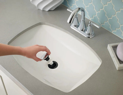 Hand installing Drain Stopper For Push And Seal Drain Assembly Polished Chrome Genuine Replacement Part 972098A in sink
