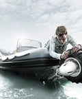 Person adjusting a motor on an inflatable boat on water
