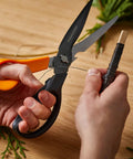 All In One Garden Tool 7-In-1 Pruning Shears For Plant Care With Titanium Knife in use cutting wire on wooden table