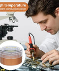 Person using Copper Conductive Grease For Electrical Contacts And Automotive Systems With Extreme Temperature Resistance