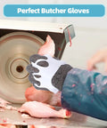 Cut Resistant Tough As Nails Stainless Steel Chainmail Glove For Meat Cutting Oyster Shucking And Fish Slicing Food Grade 316 Stainless Steel Butcher Glove Hygienic Easy To Clean Size Small being used in a kitchen environment with a meat slicer.