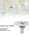 Automatic Glass Rinser And Cup Washer For Sink With 360 Degree Rotation Stainless Steel G One Half Attachment Quick Rinse Multi Angle Head No Scrub Clean For Home And Cafe Cleans Bottles Cups And Glassware Fast, shown with glasses in background.