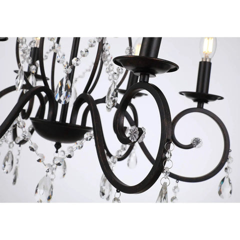 Close-up of a bronze crystal six light candle chandelier with metal pendant ceiling light for bedroom and dining room.