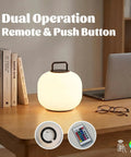 Cordless RGBW LED Table Lamp With Remote Control, Portable Outdoor Lantern on desk with books, laptop, and glasses.