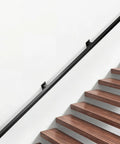 Hella Sturdy Indoor Stair Handrail 9 FT Modern Wrought Iron Railing With Dope Matte Black Powder Coated Finish Reinforced Square Design For Farmhouse Decor mounted on a staircase.