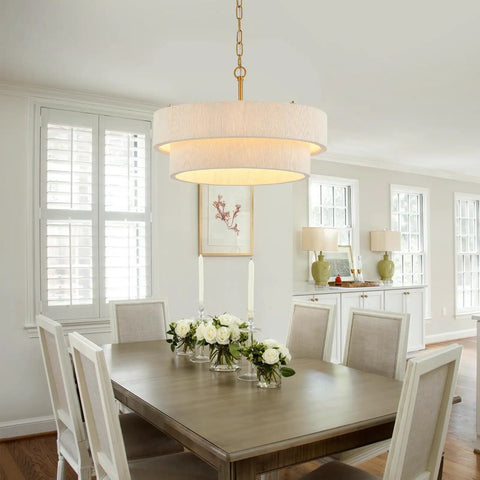 Hand Woven Rattan Chandelier Serving Real Boho Vibes And Adjustable Coastal Design above a dining table with flowers.