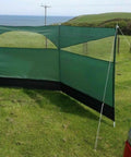 Forest Green 5 Panel Wind Privacy Screen Windbreaker for Camping, Garden or Beach, set up outdoors with guy lines and steel pegs