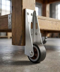 Heavy Duty Vertical Track Roller Wheels For Sliding Barn Doors And Wood Gates Featuring Silent Rubber Casters and upgraded Anti Sag Bearings on a wooden frame.