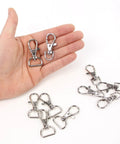 DIY Hobby Horse Halter Kit For Stick Horses, metal snap hooks for reins, two in hand, additional hooks on white surface.