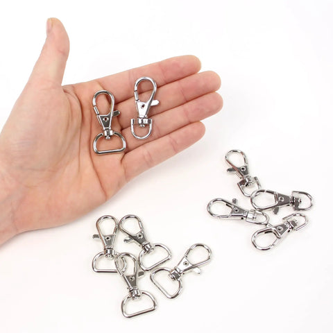 DIY Hobby Horse Halter Kit For Stick Horses, metal snap hooks for reins, two in hand, additional hooks on white surface.