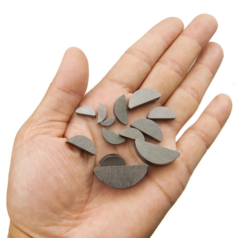 Hand holding semicircle woodruff keys from Garage Grade 75 Piece Woodruff Key Set With 15 Sizes Semicircle Half Moon Keyways For Shafts And Cranks In Automotive And Industrial Machinery Tools Carbon Steel Corrosion Resistant 5 Of Each Size Pack