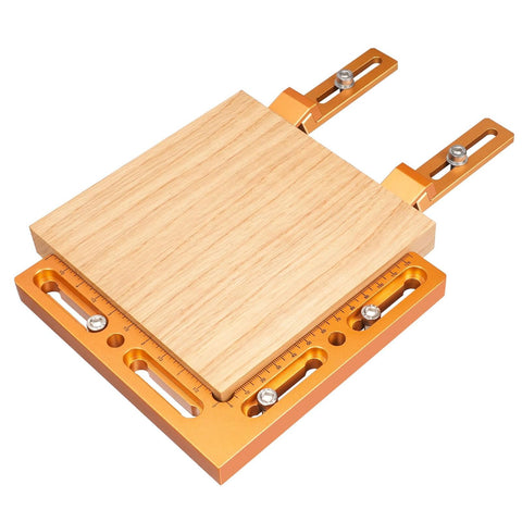 Rock Solid CNC Workpiece Positioning Fixture Kit With T Slot Perforated Table And Hella Accurate Woodworking Vise Clamps, featuring wooden base and orange aluminum mounts.