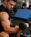 Man using Preacher Curl Pad With Non Slip Base For Home Gym Arm Support 16x8 Inch Cushion High Density Foam for biceps exercise